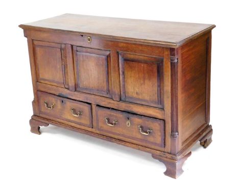 A George III oak and mahogany mule chest, with a hinged lid over a triple panelled front, flanked by fluted corner pilasters,