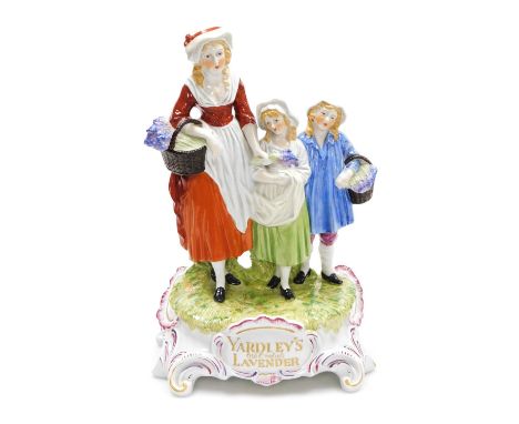 A 20thC Dresden porcelain figure group, for Yardley's Old English Lavender, modelled with a woman and two girls, carrying bas