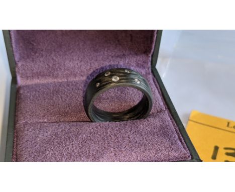 Ring understood to be made of carbon &amp; diamonds - no price sticker or labelling on this ring. The ring is stamped "0.14ct