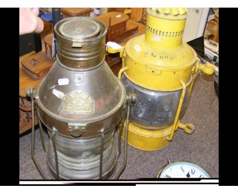 One copper and one yellow painted ship's anchor lights  CONDITION REPORT Copper lamp -- Height 47cm, 22cm diam, chips to glas