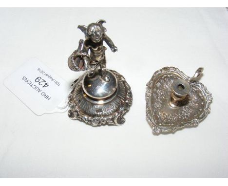 A miniature silver winged putto statuette - Sheffield import 1899, together with a miniature chamber stick - Continental mark