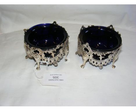 A pair of Victorian pierced silver table salts with blue glass liners - 8cm diameter - maker Yapp and Woodward, Birmingham 18