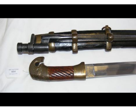 A Russian Shashqa with wooden grip - the slightly curved blade engraved 1926 - having leather scabbard and mounted sword bayo