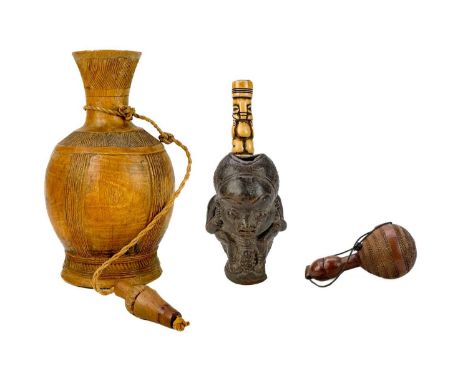 A Bakongo carved powder flask.  Height 11.5cm together with a larger carved flask and a terracotta and bone pipe.(3)  Maurice