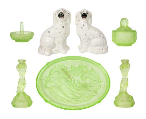 A 1930s uranium glass dressing table set. Comprising a pair of mermaid candlesticks, an oval tray with mermaid, fish and shel