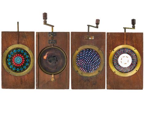 A set of three mechanical chromotrope double rackwork magic lantern slides. Together with a single rackwork magic lantern sli