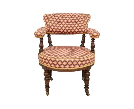 A Victorian walnut upholstered tub chair. With turned supports and castor wheels, height 81cm width 65cm depth 78cm.The joint