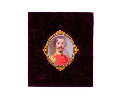 English school, early 19th century.  An oval portrait miniature of an officer, in an ornate gold frame, 4.8X4cm, in a leather