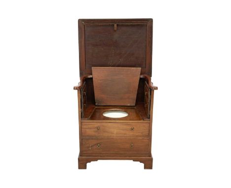 A 19th century mahogany night commode. With a rising top, the front fashioned as dummy drawers and cupboards, with a ceramic 