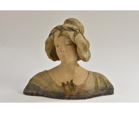 A French Art Nouveau style painted terracotta bust of a young beauty, her garment with moulded lyre motif, a garland of leave