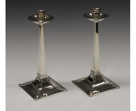 A pair of silver table candlesticks,  in the manner of Archibald Knox,  tapering square stems riveted angles, spreading bases