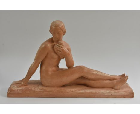 After Bargas, a French Art Deco style model of a resting nude, she sits pensively holding a dove to her breast, 63cm wide, 38