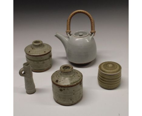 Joanna Constantinidis (1927-2000) - a cylindrical pot and cover, mottled tan glaze, 8cm high, seal mark;  another, similar;  