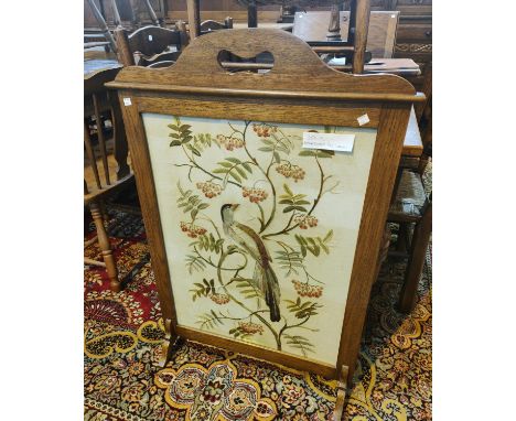 A large oak tapestry fire screen with bird on branches 