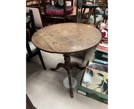 An oak circular tilt top table on tripod base with column and a mahogany fall front desk top unit 