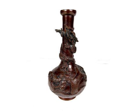 A Japanese bronze bottle vase with dragon in relief entwined around the neck, ht. 18cm. Top rim slightly misshapen, some corr