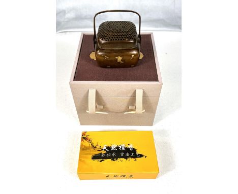 A 20th century Chinese bronze censor with gilt highlights, seal mark to base in presentation boxGood condition 