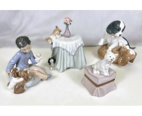 Three Lladro groups: boy with puppies Growing Up Together, dog on a stool, cat and puppy playing; a Nao group of dogs playing