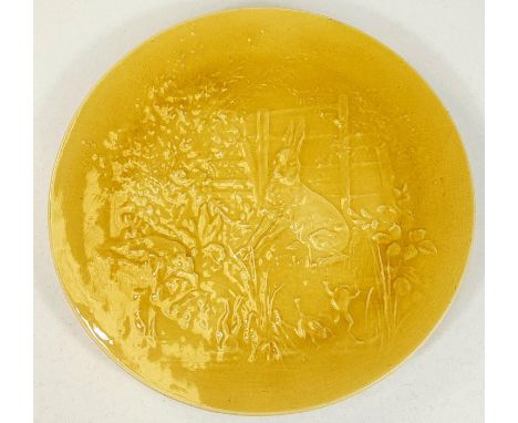 Burmantofts: A circular yellow glazed wall plate depicting scene from Aesop's fables, "Hare and Frogs", impressed Pierre Mall