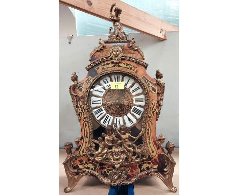 A Louis XV Rococo style boulle mantle clock with extensive inlaid and gilt metal cherub mounts with striking French movement,