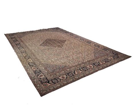 A good and large Isphahan carpet, central dark blue lozenge medallion on ivory field, all-over foliate design, light blue spa