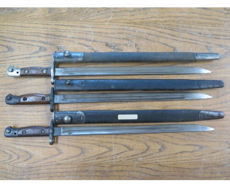 Three United Kingdom 1907 pattern Lee Enfield .303 Bayonets, all with scabbards - overall length 57cm, all marked 1907 with G