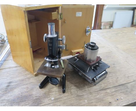 A Watson Barnet Service microscope with case and a Polaroid camera adapted for scientific use