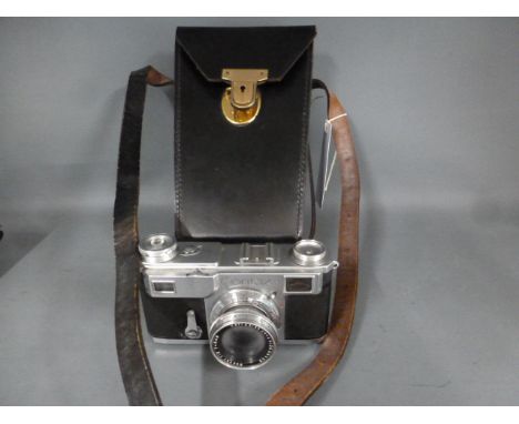 A Contax II Rangefinder camera, chrome no. Q65268 with Carl Zeiss Jena Sonnar 1:2 F=5cm lens, instruction booklet and leather