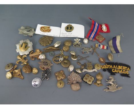A collection of Military badges and button, some ribbons amongst