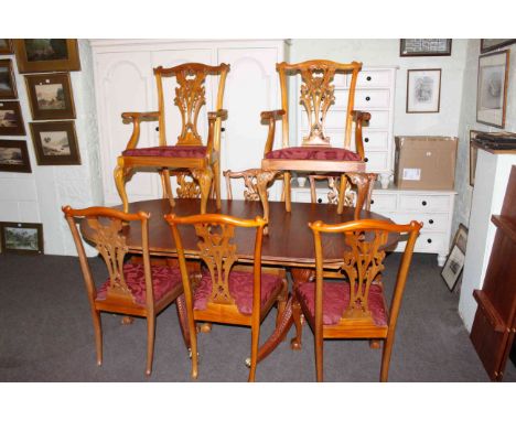 Twin pedestal extending dining table and two leaves together with a set of eight Chippendale style chairs including pair carv