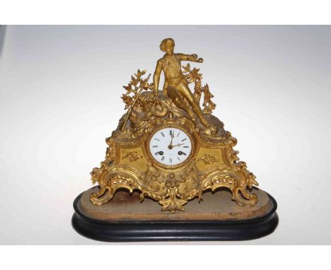 Ornate gilt metal mantel clock depicting a young boy, labelled Reid &amp; Sons, Paris, 40cm high.