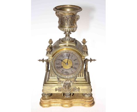 Ornate brass mantel clock with urn top and stand, 46cm high.