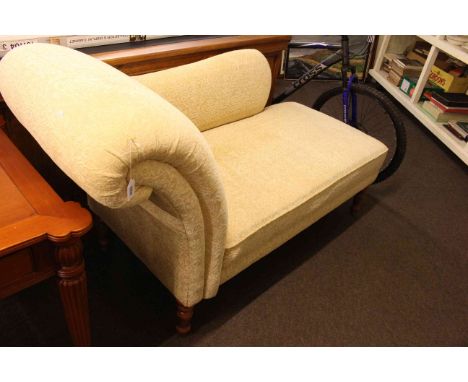 Modern chaise longue on turned legs in light yellow fabric.