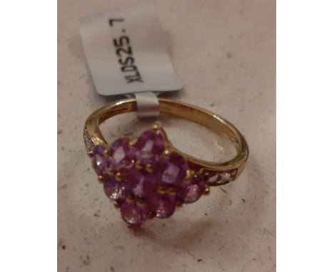 A Gemporia 9ct gold ring with 9 natural purple sapphires and 2 white zirconias to the sides, with certificate of authenticity