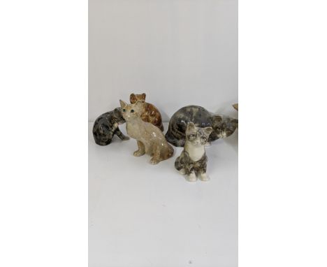 A group of seven Winstanley ceramic cats to include a Winstanley ginger cat with glass eyes, 21cm h and others, on A/FLocatio
