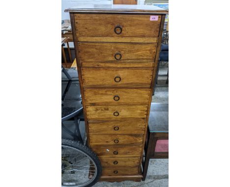 A modern hardwood, ten drawer tall boy with iron ring handles, on bracket feet, 150 x 50 x 36.5cm, Location: G 