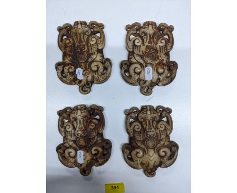 A group of four Chinese white jade plaques denoting the four seasons, in the form of flattened lion dogs Location: 5.4 