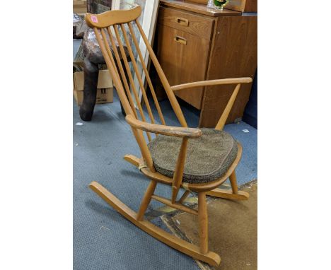 A blonde Ercol Goldsmith rocking chair with an attached brown cushion, Location: 