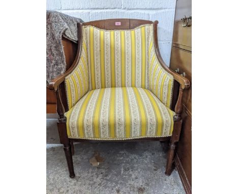 An inlaid mahogany upholstered armchair, on ring turned and tapering front legs, circa 1900 