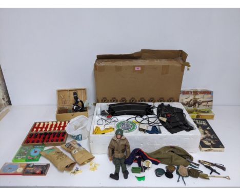 A mixed selection of toys to include an Action Man with kit bag containing various accessories, caps and guns, Scalextric set