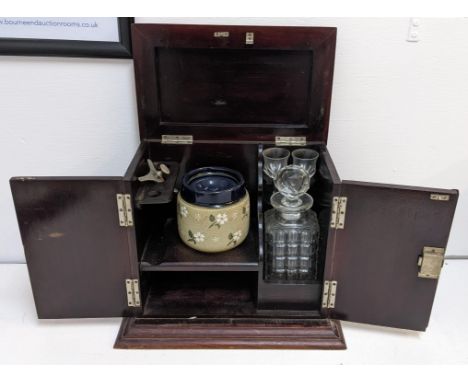 An early 20th century mahogany smokers cabinet with a decanter and glasses, Location: 