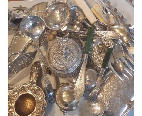 A collection of silver and plated items to include a silver strainer , indian silver and Jade handled silver cutlery