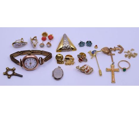 A collection of 9ct gold items to include charms, corpus, yellow metal mounted shell, opal earrings and similar (qty)