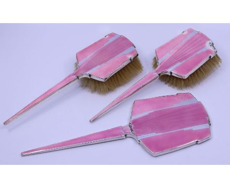 A silver Art Deco dressing set, finished in pink guilouche enamel
