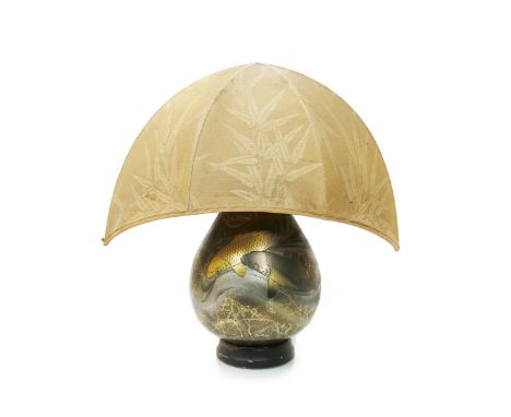 A lacquered metal lamp base, swollen ovoid form decorated with two carp swimming in turbulent waters, on wooden base, with si