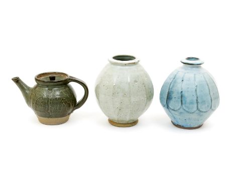 Mike Dodd (born 1943) a cut-sided stoneware vase, covered to the foot in a pale blue glaze, a Mike Dodd  teapot and cover and