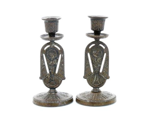 A pair of William Impey Aesthetic Movement cast iron candlesticks, cast in low relief with stylised floral panels, a cast bra