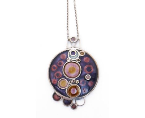 A silver and enamel pendant necklace by Alastair Norman Grant,  disk form with wirework  circles, enamelled in shades of purp