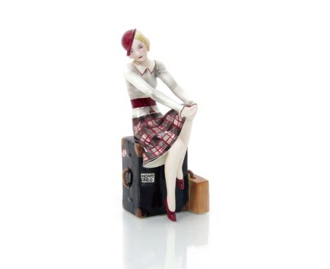 A rare Goldscheider Pottery model of a woman sitting on her luggage trunk designed by Stephan Dakon,  model no.7172, painted 