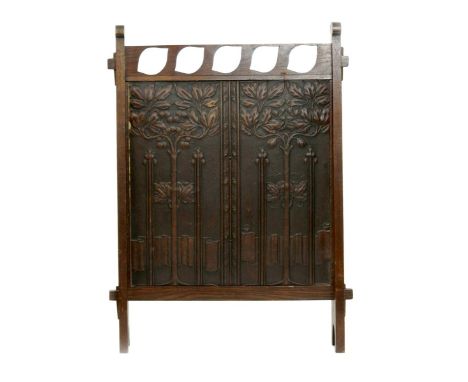 A Liberty & Co oak firescreen set with Letho panel, the rectangular frame with pierced leaf shaped decoration, the Letho pane